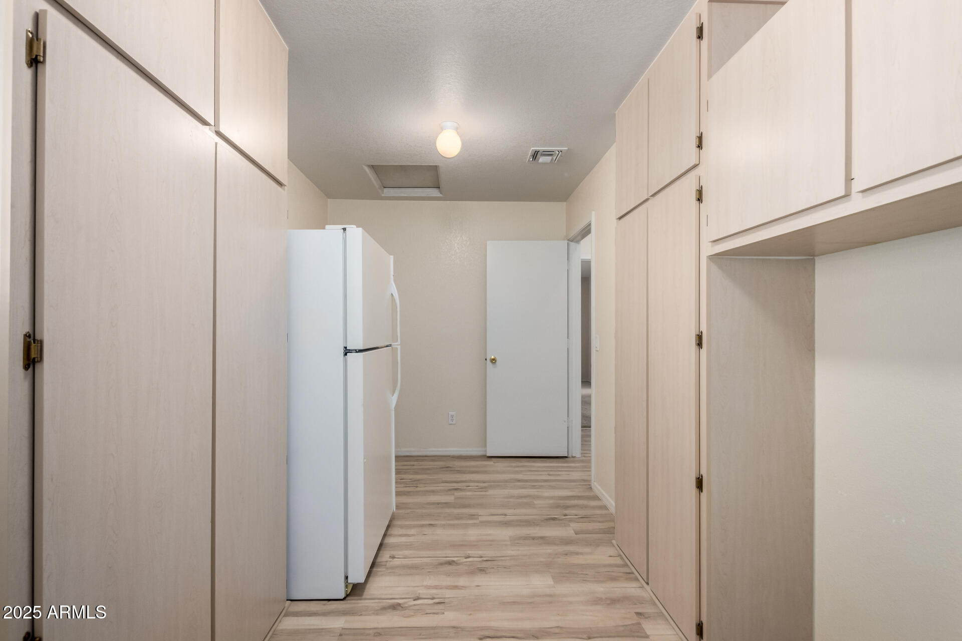2101 South Meridian Road, Unit 301 Apache Junction, AZ 85120 - Photo 16 of 30 a view of a hallway with wooden floor and staircase