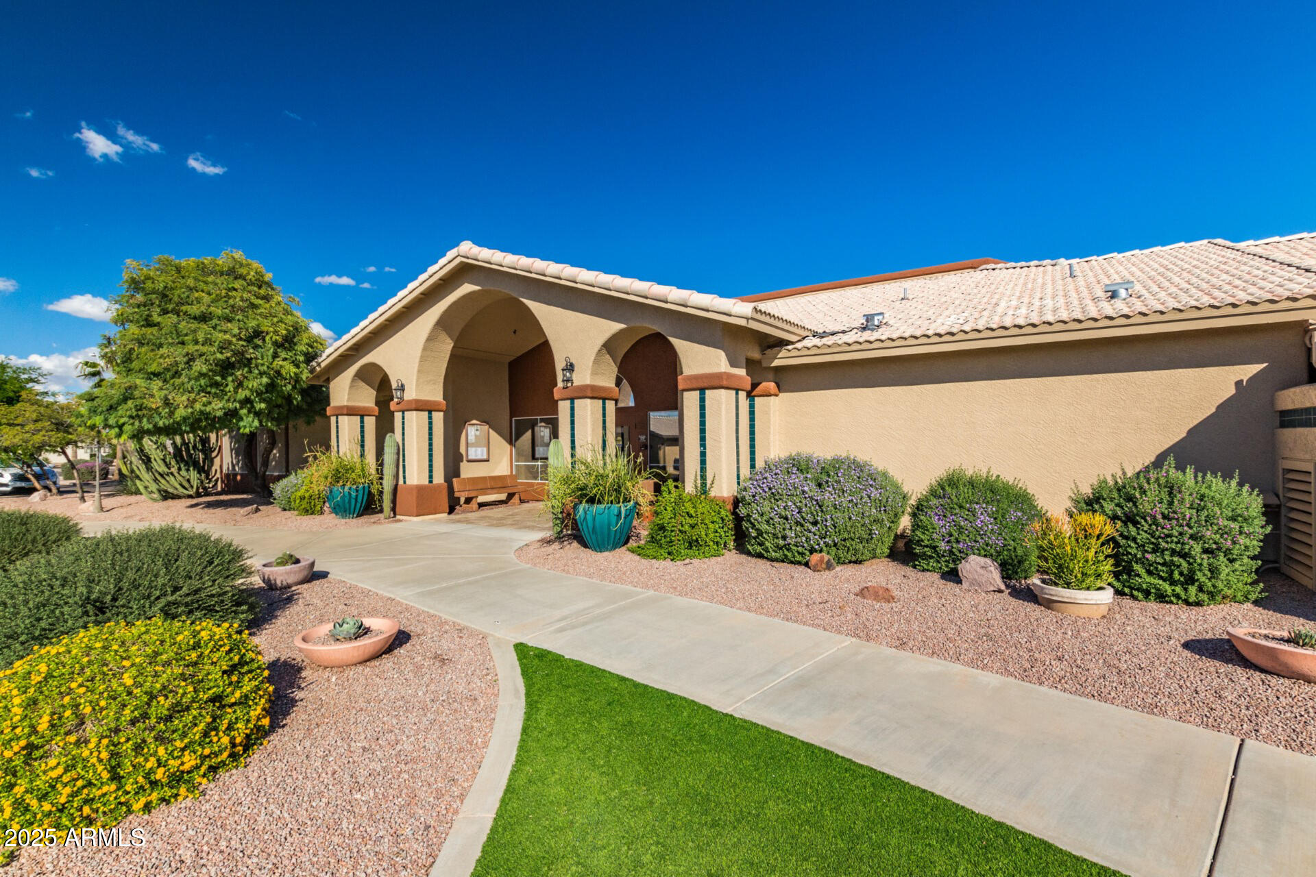 2101 South Meridian Road, Unit 301 Apache Junction, AZ 85120 - Photo 21 of 30 a front view of a house with a yard