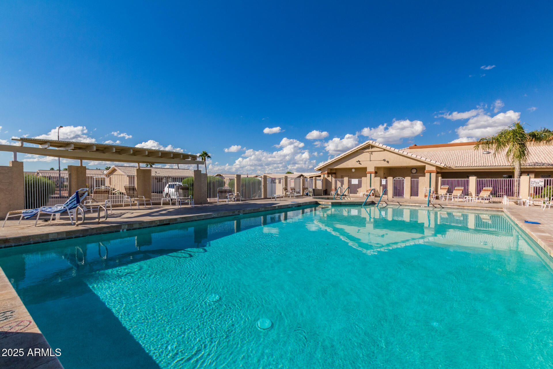 2101 South Meridian Road, Unit 301 Apache Junction, AZ 85120 - Photo 23 of 30 a front view of a house with swimming pool having outdoor seating