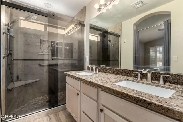 a bathroom with a granite countertop sink mirror and double
