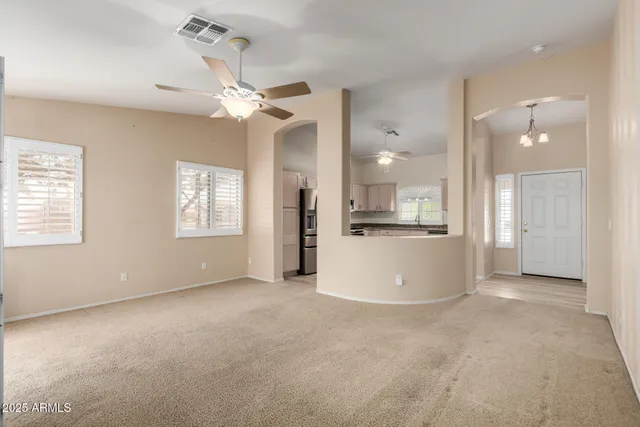 a view of a kitchen with a kitchen island wooden floor and a ceiling fan