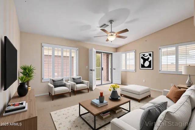 a living room with furniture a chandelier and a window