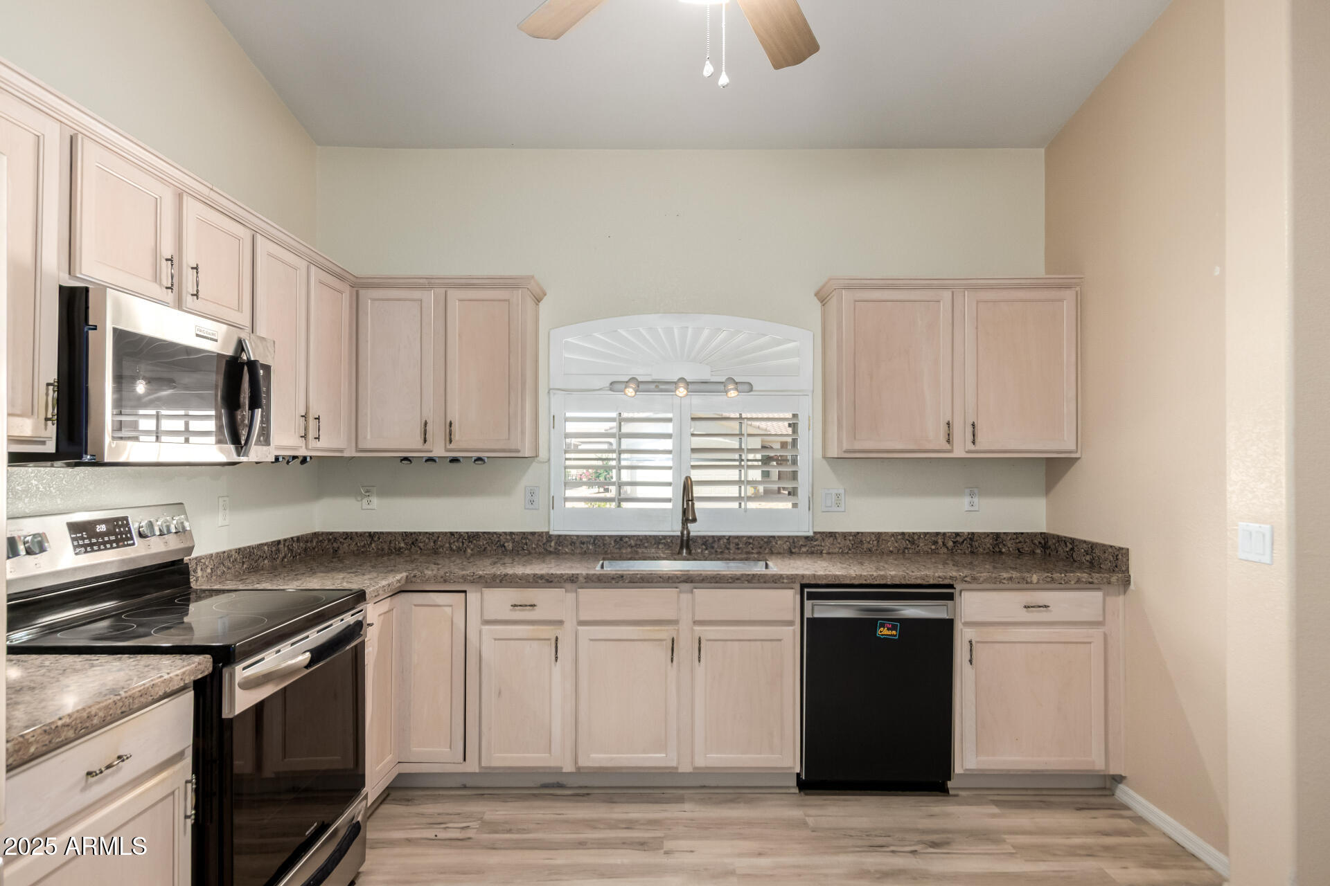 2101 South Meridian Road, Unit 301 Apache Junction, AZ 85120 - Photo 8 of 30 a kitchen with granite countertop white cabinets and stainless steel appliances