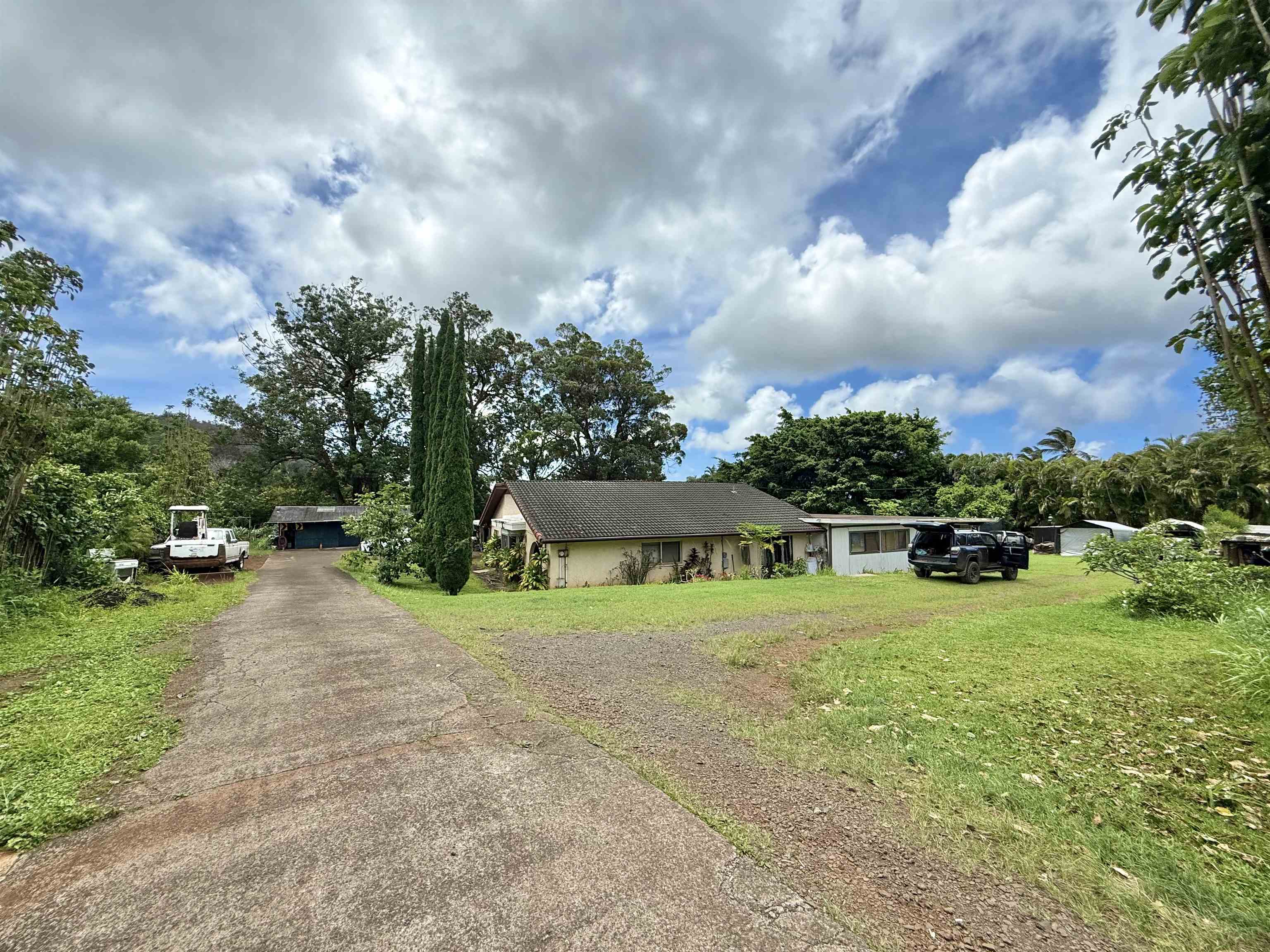 1630 Kauhikoa Road Haiku, HI 96708 - Photo 9 of 48 a view of a garden with a house in the background