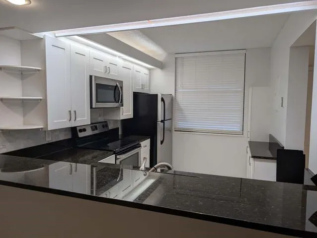 a kitchen with a sink and a refrigerator