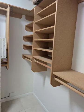 a view of walk in closet with empty racks
