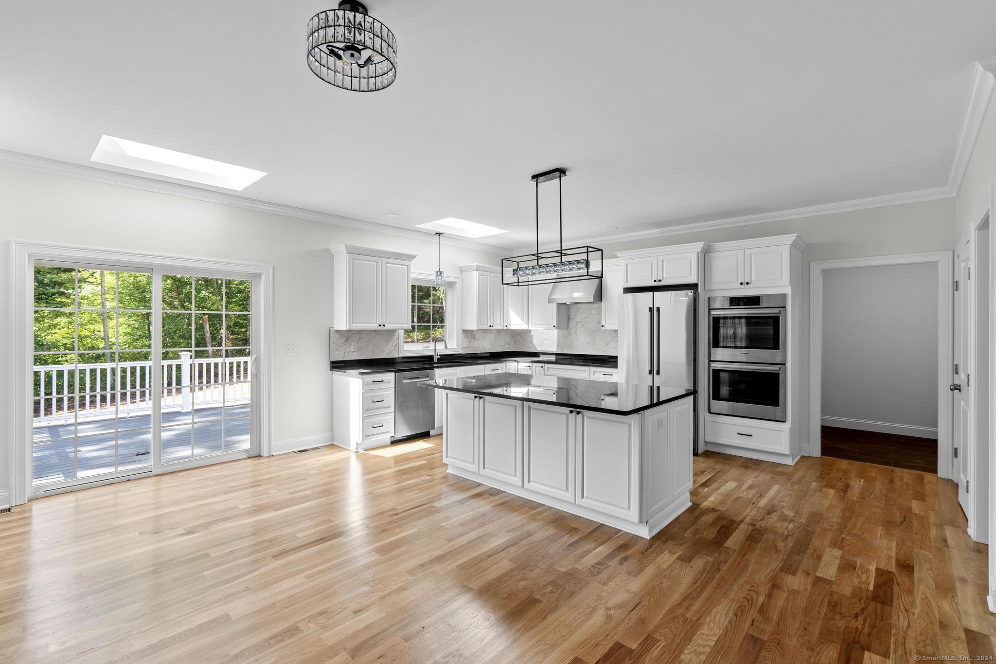 289 Young Street East Hampton, CT 06424 - Photo 4 of 15 a kitchen with stainless steel appliances wooden floor and a refrigerator