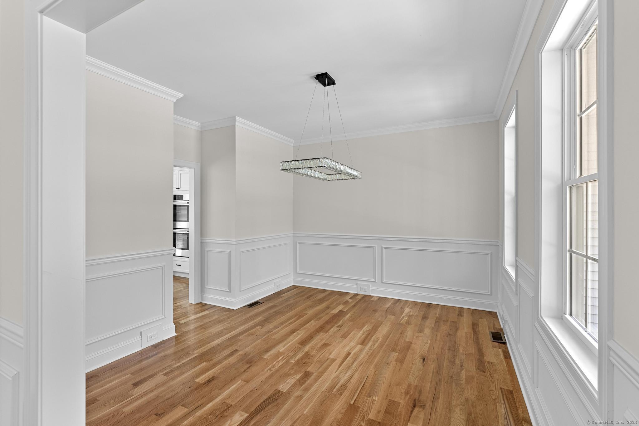 289 Young Street East Hampton, CT 06424 - Photo 5 of 15 wooden floor in an empty room with a window