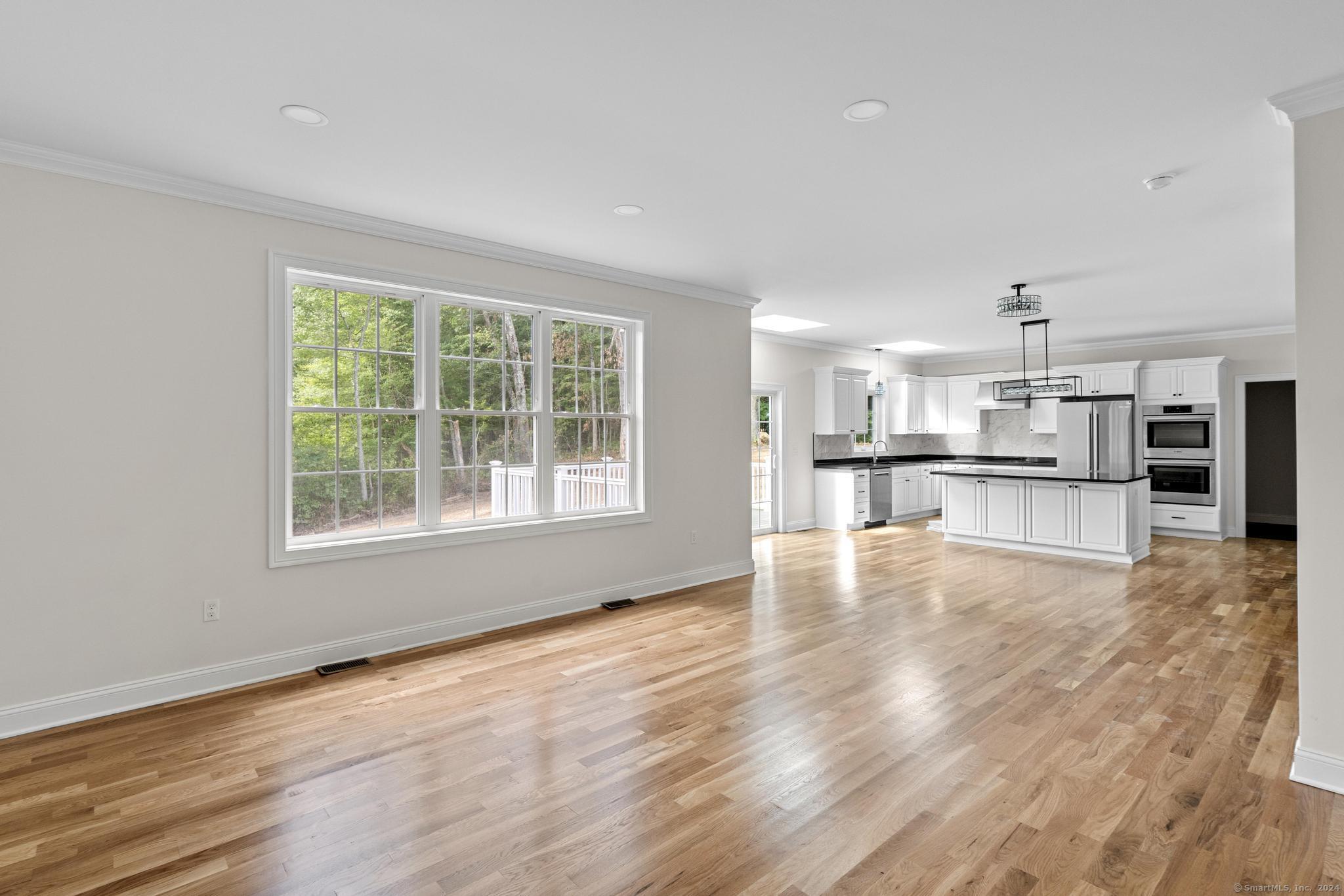 289 Young Street East Hampton, CT 06424 - Photo 7 of 15 a view of kitchen with wooden floor and windows