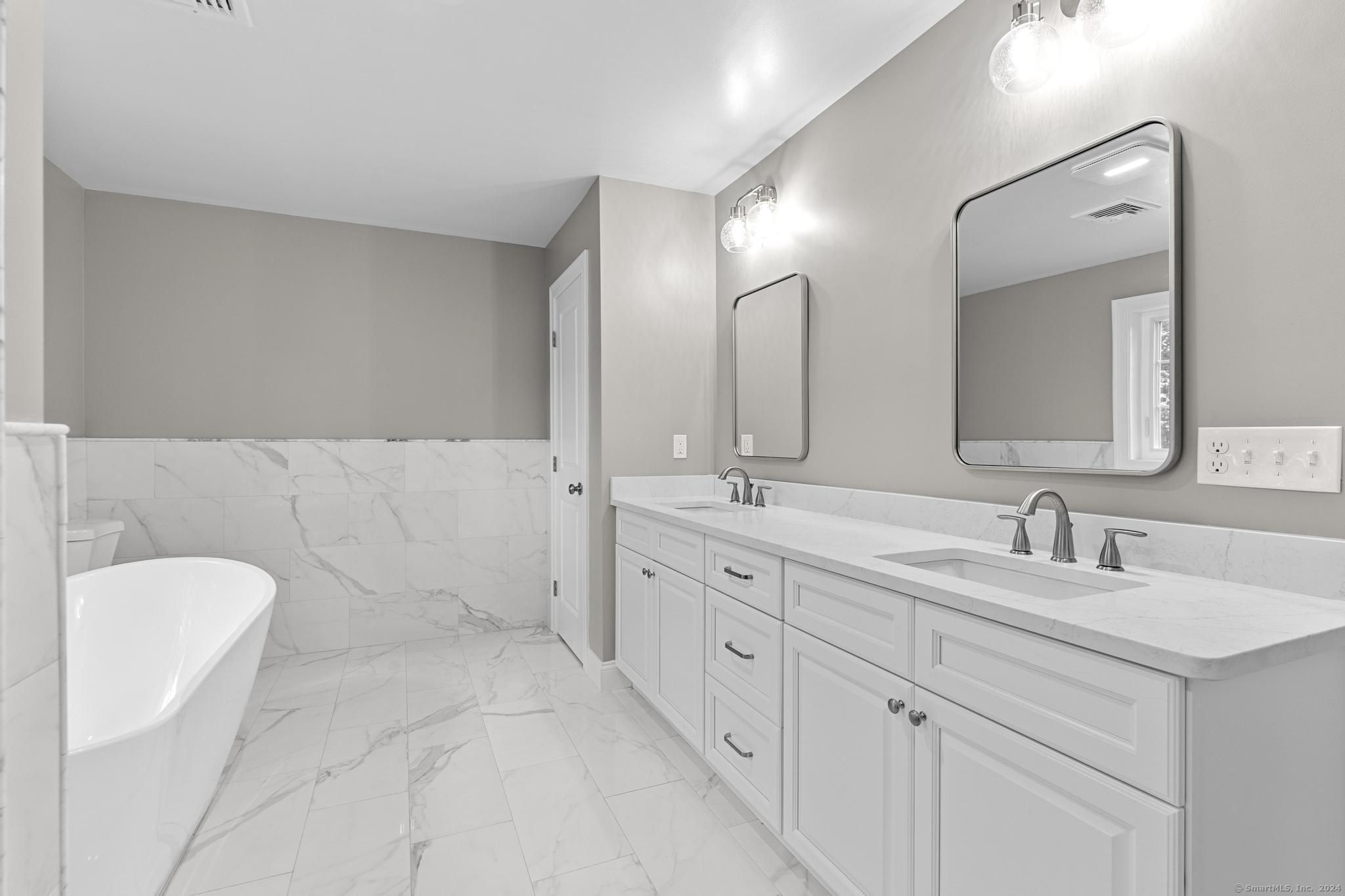 289 Young Street East Hampton, CT 06424 - Photo 9 of 15 a spacious bathroom with a double vanity sink mirror and bathtub
