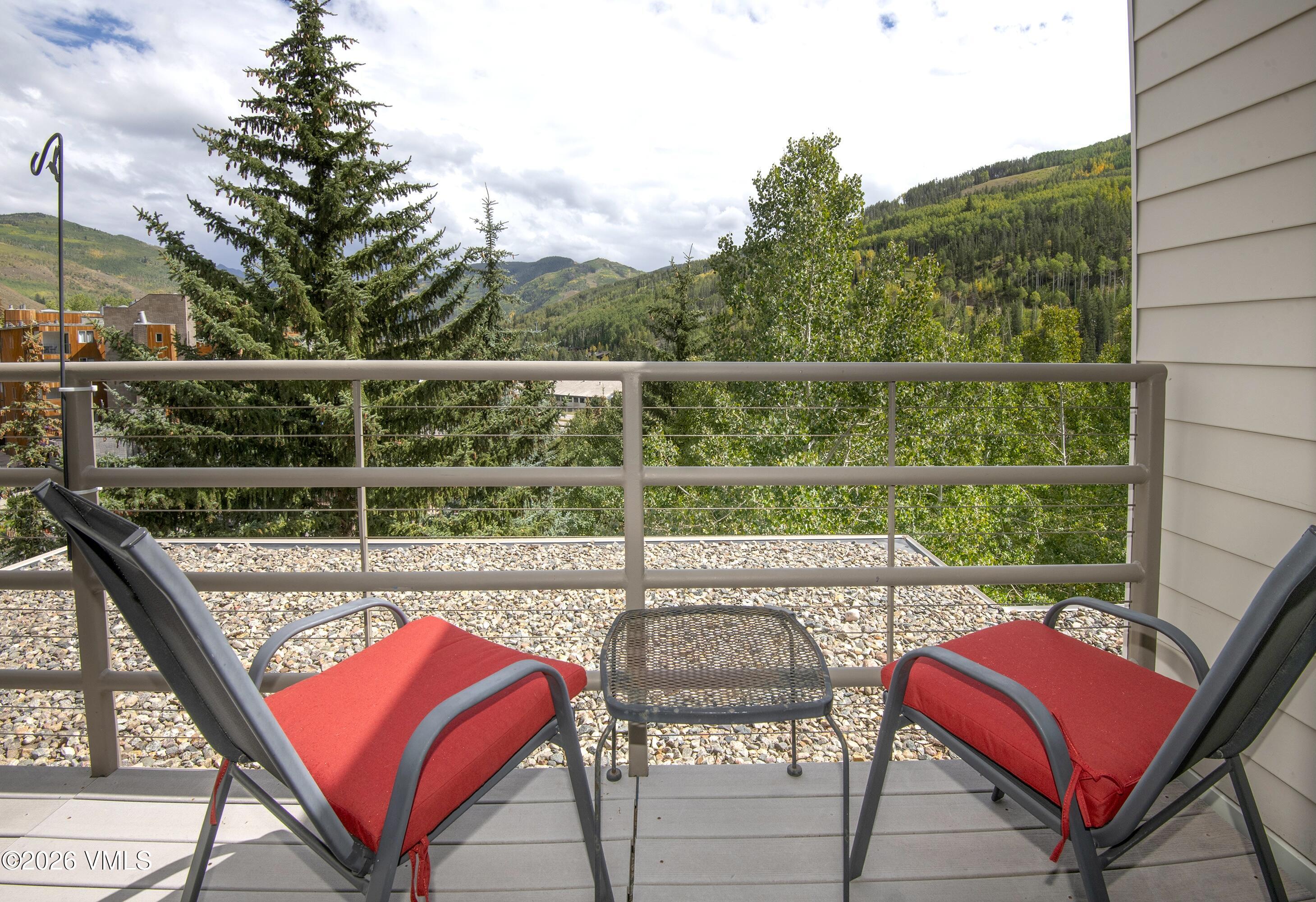 1100 North Frontage Road West, Unit 1519 Vail, CO 81657 - Photo 4 of 38 a view of a chairs and table in the balcony