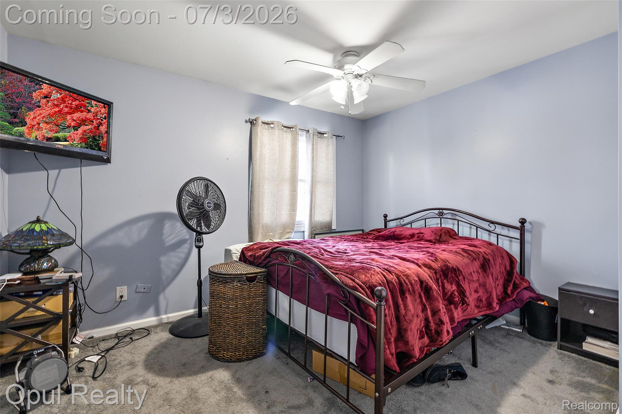 8855 Gross Road Dexter, MI 48130 - Photo 44 of 53 Bedroom featuring light blue walls, gray carpet flooring, and a ceiling fan with light fixture