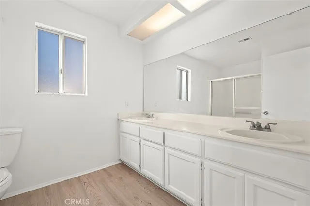 a white toilet sitting next to a shower