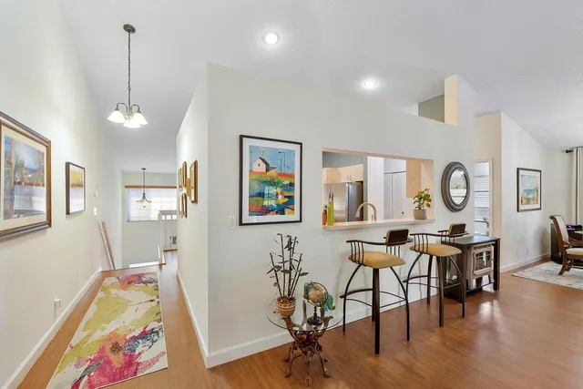 a view of a room with furniture and wooden floor