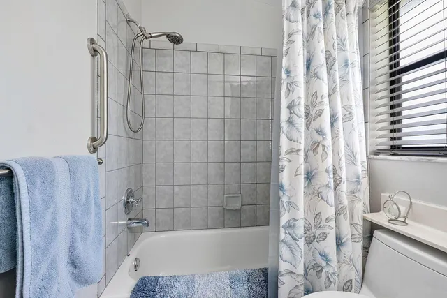 a bathroom with a shower curtain and a bathtub