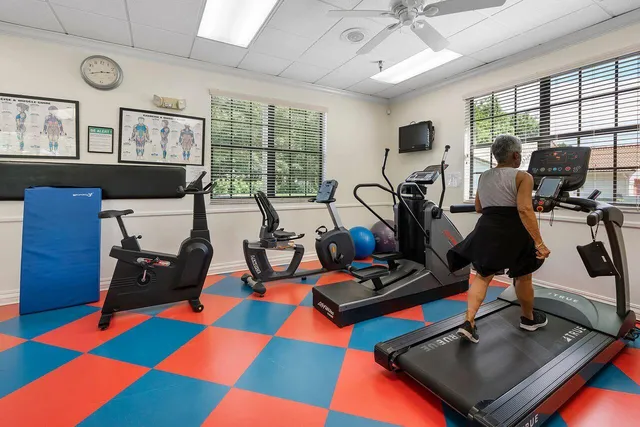 a room with gym equipment and windows