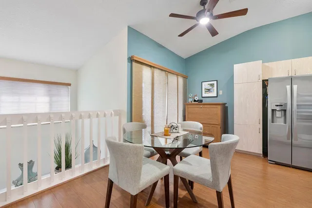 a dining room with furniture a window and wooden floor
