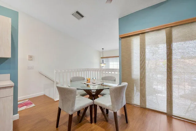 a view of a dining room with furniture and wooden floor