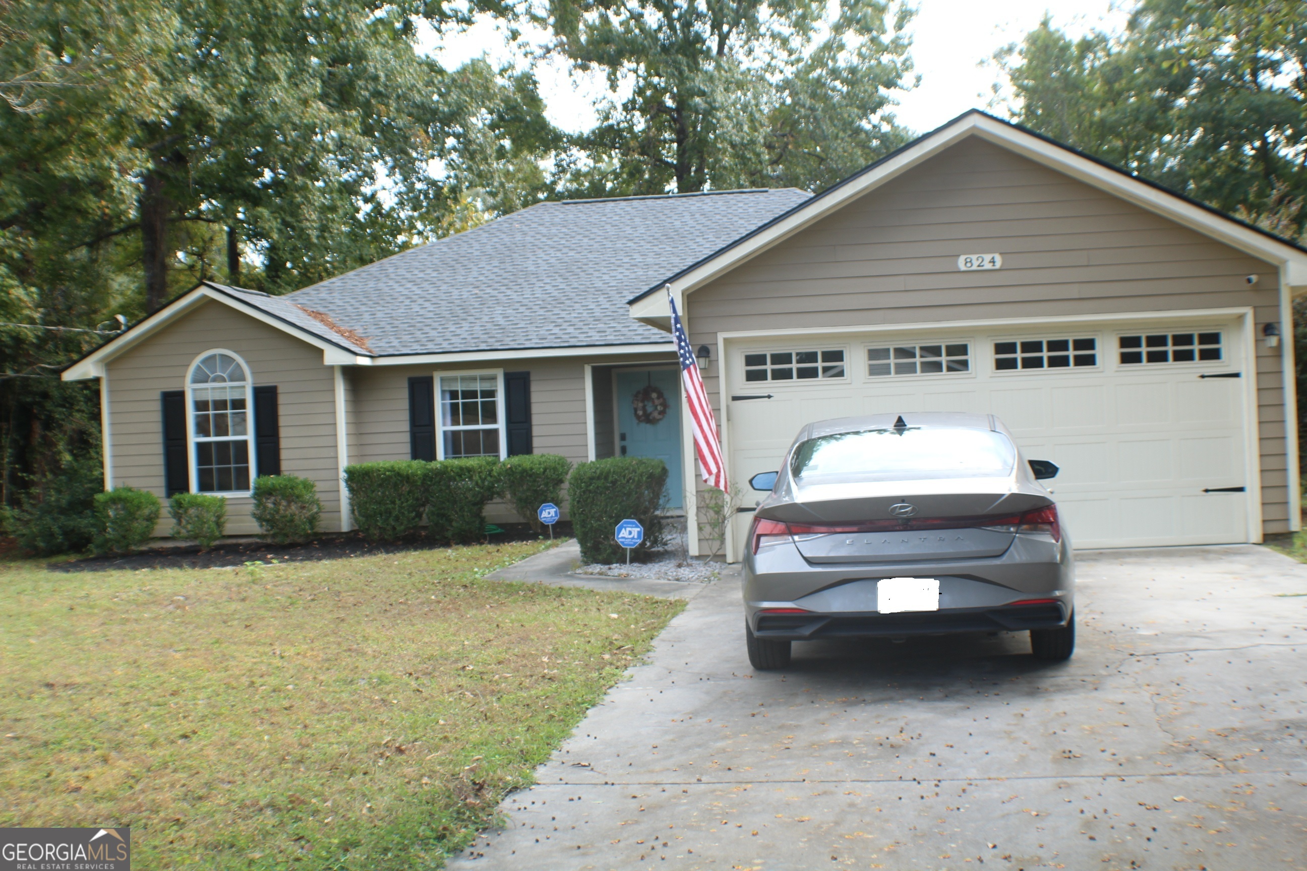824 East Hilton Avenue Kingsland, GA 31548 - Photo 1 of 20 a front view of a house with a yard and garage