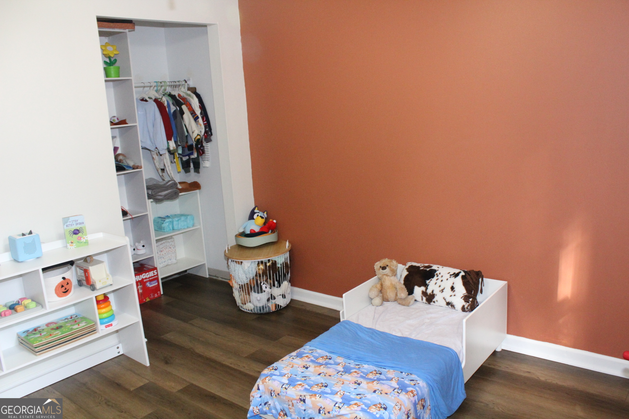 824 East Hilton Avenue Kingsland, GA 31548 - Photo 15 of 20 a bedroom with a bed and a wooden floor