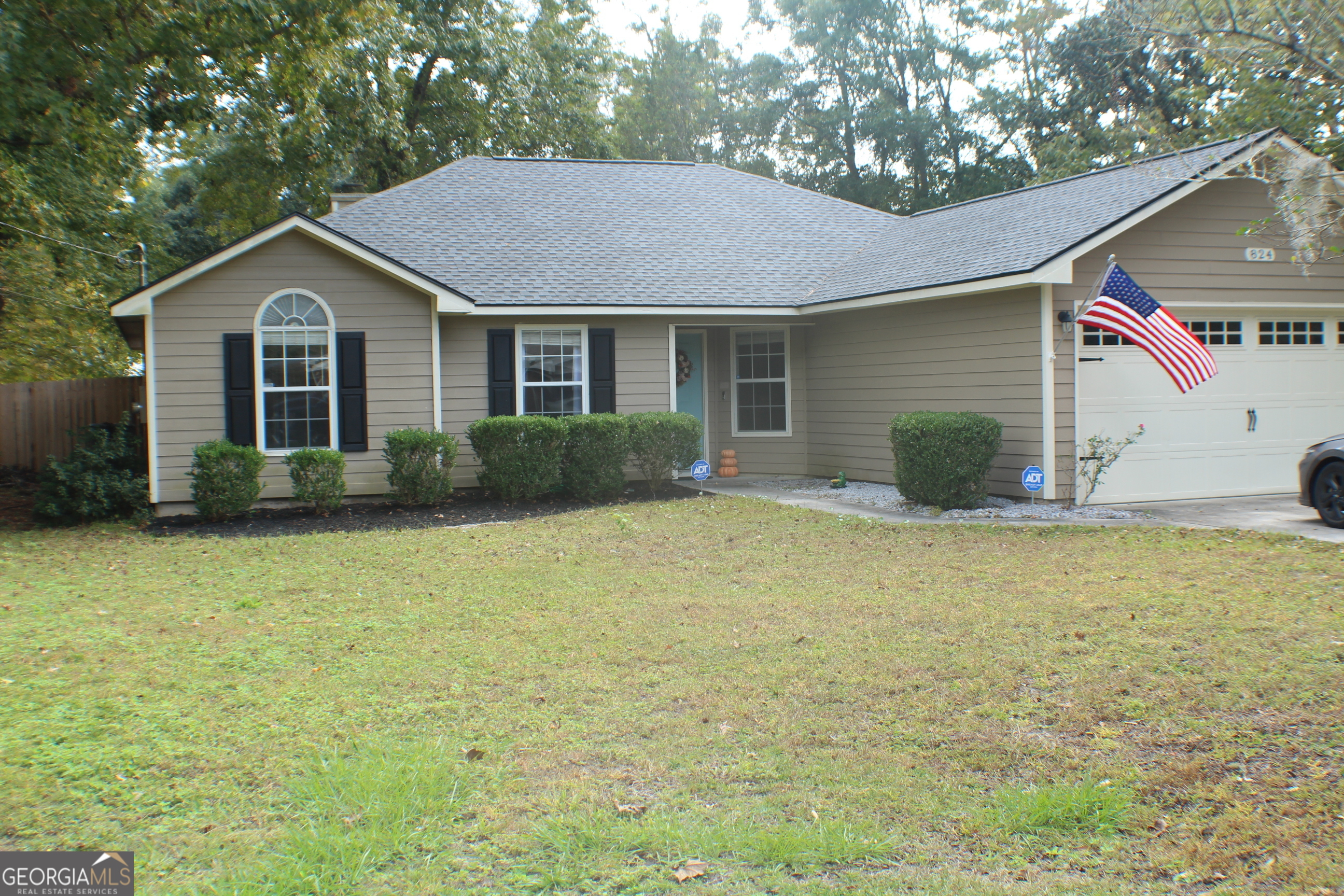 824 East Hilton Avenue Kingsland, GA 31548 - Photo 2 of 20 a front view of house with yard and trees in the background