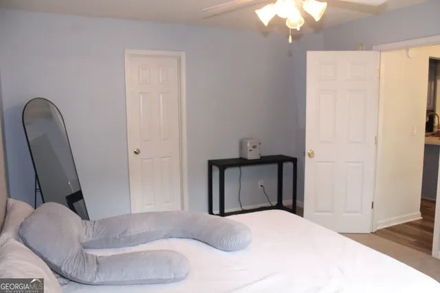 a bedroom with a bed and a chair
