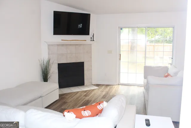 a living room with a fireplace and a flat screen tv