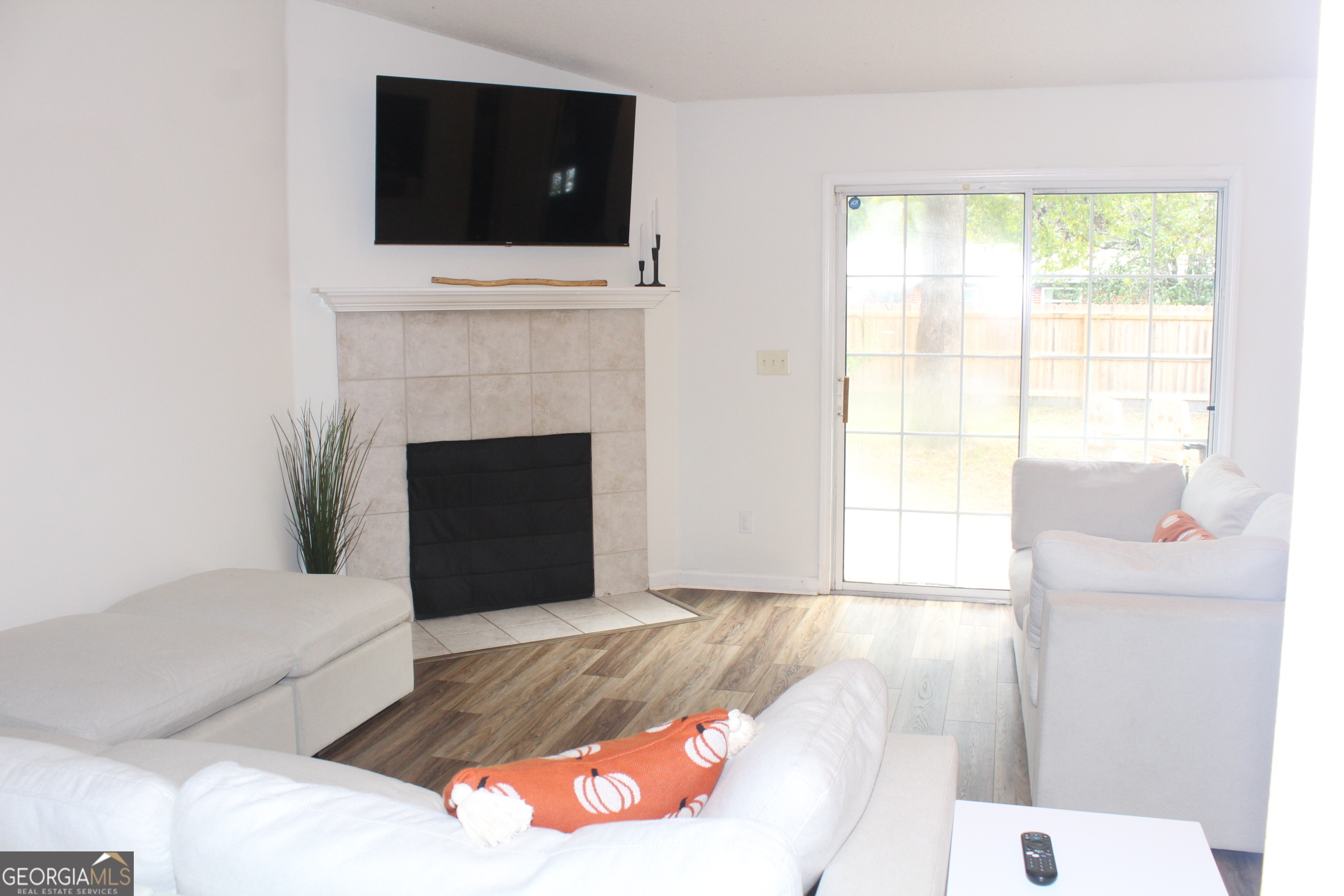 824 East Hilton Avenue Kingsland, GA 31548 - Photo 6 of 20 a living room with a fireplace and a flat screen tv
