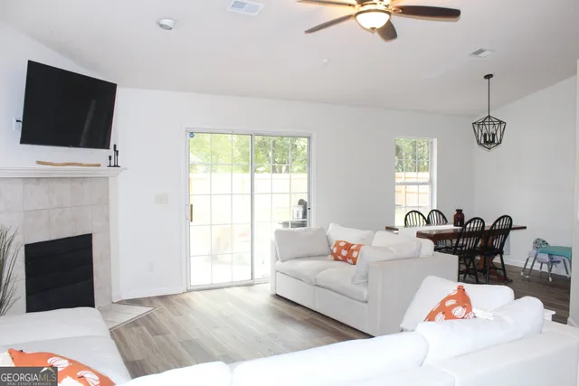 a living room with furniture fireplace and flat screen tv