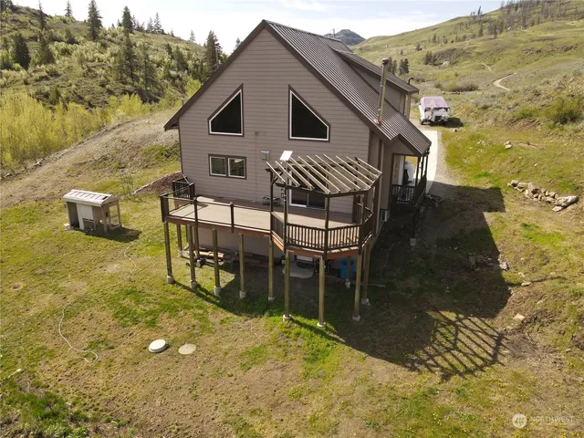 a view of a house with backyard porch and sitting area
