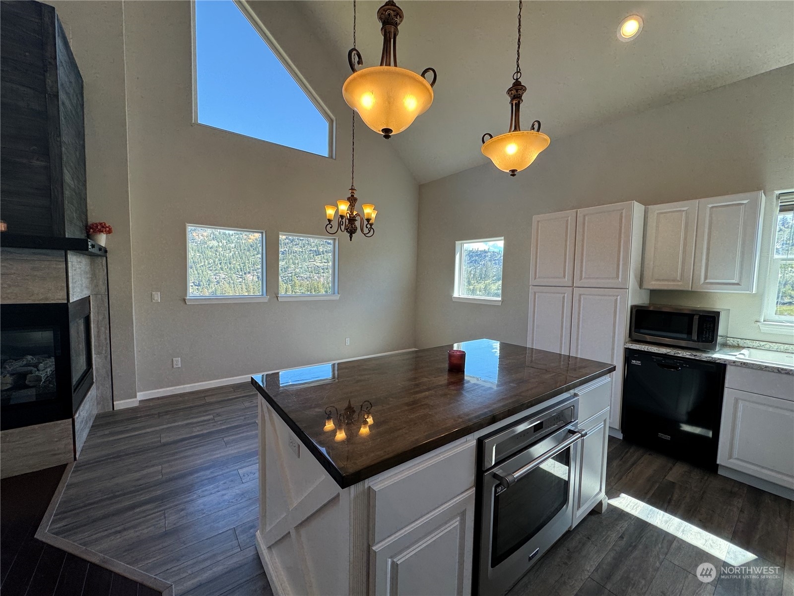 4 Eighme Road Oroville, WA 98844 - Photo 11 of 40 a kitchen with stainless steel appliances granite countertop a stove and a wooden floor