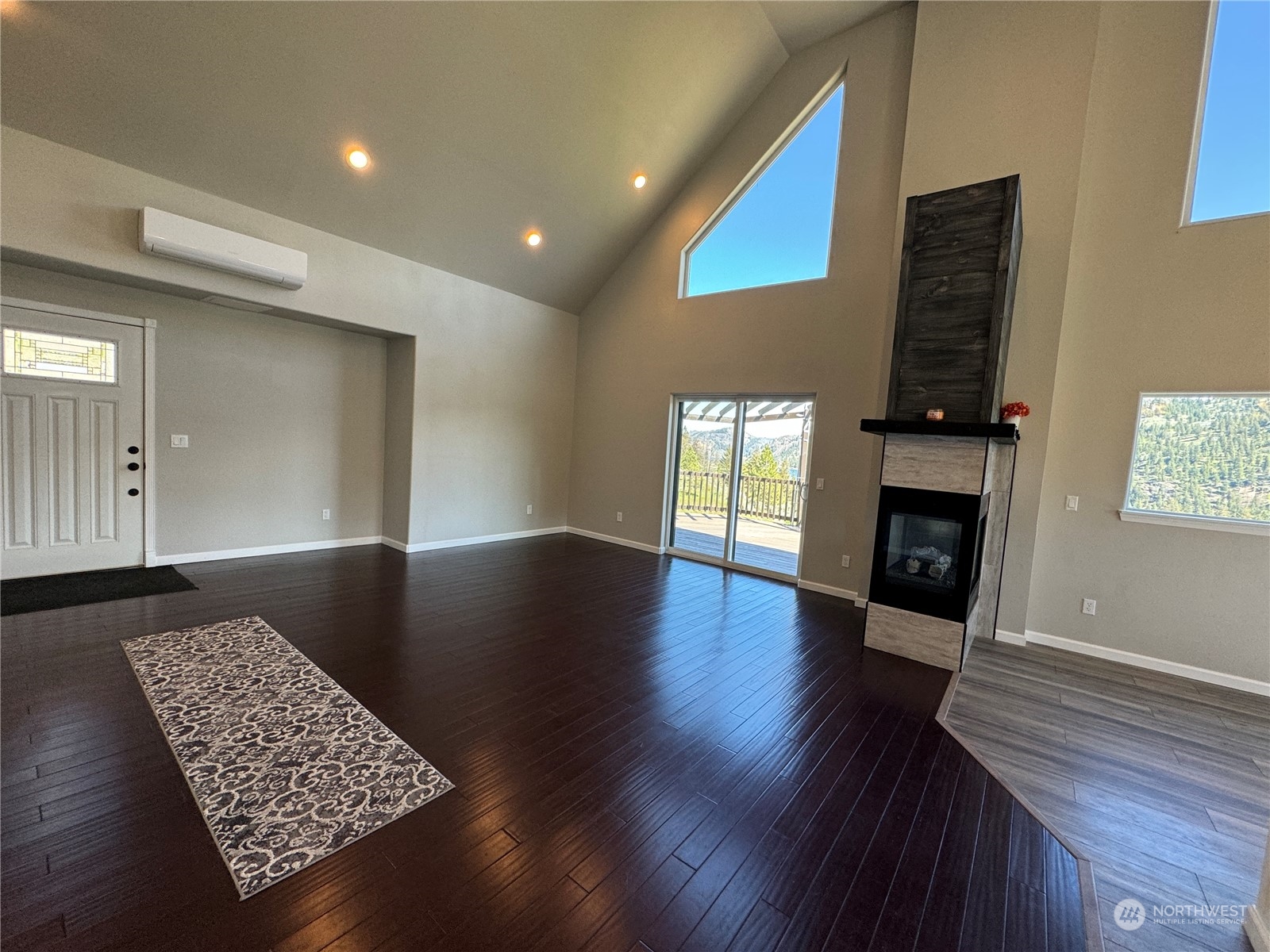 4 Eighme Road Oroville, WA 98844 - Photo 8 of 40 a view of an empty room with wooden floor and a fireplace