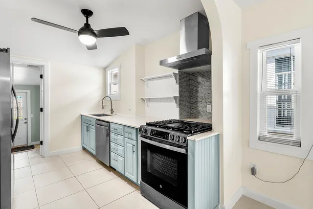 a kitchen with stainless steel appliances granite countertop a stove and a refrigerator