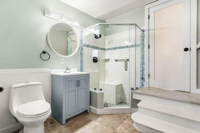 a bathroom with a sink toilet and shower