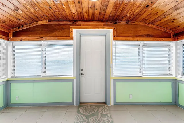 a view of door with a small yard