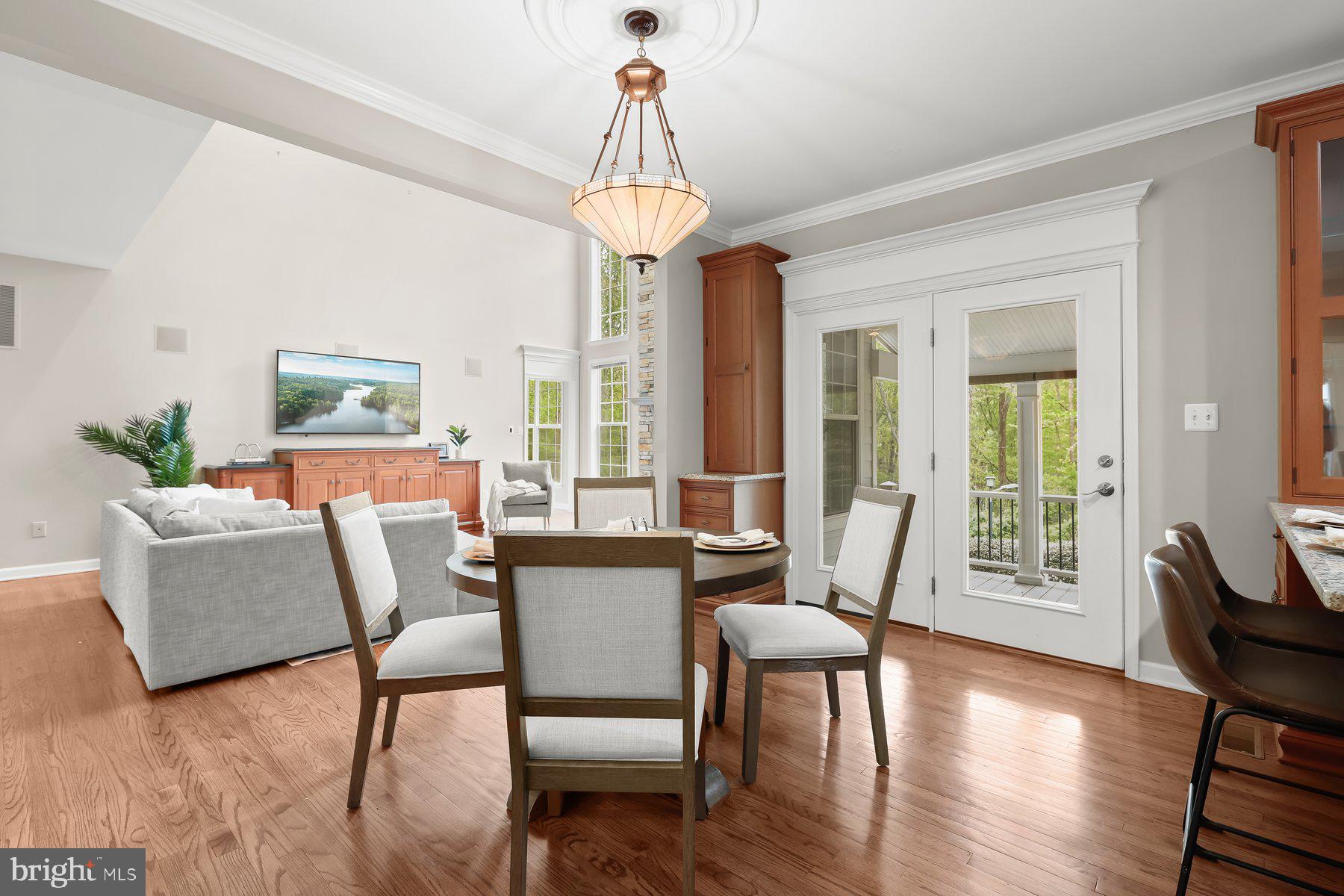 15101 Union Chapel Road Woodbine, MD 21797 - Photo 18 of 93 a dining room with furniture a chandelier and wooden floor