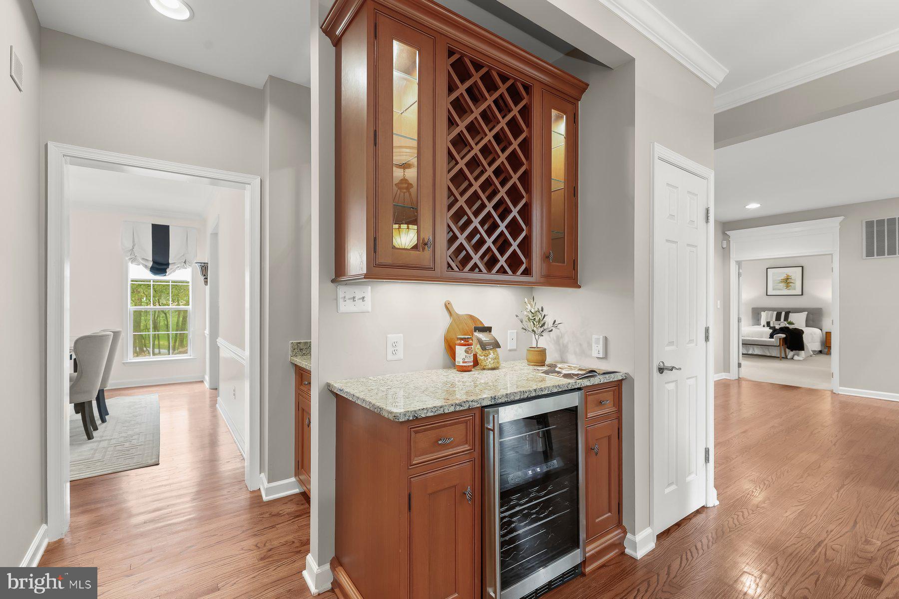 15101 Union Chapel Road Woodbine, MD 21797 - Photo 24 of 93 a kitchen with stainless steel appliances granite countertop a sink and wooden cabinets with wooden floor