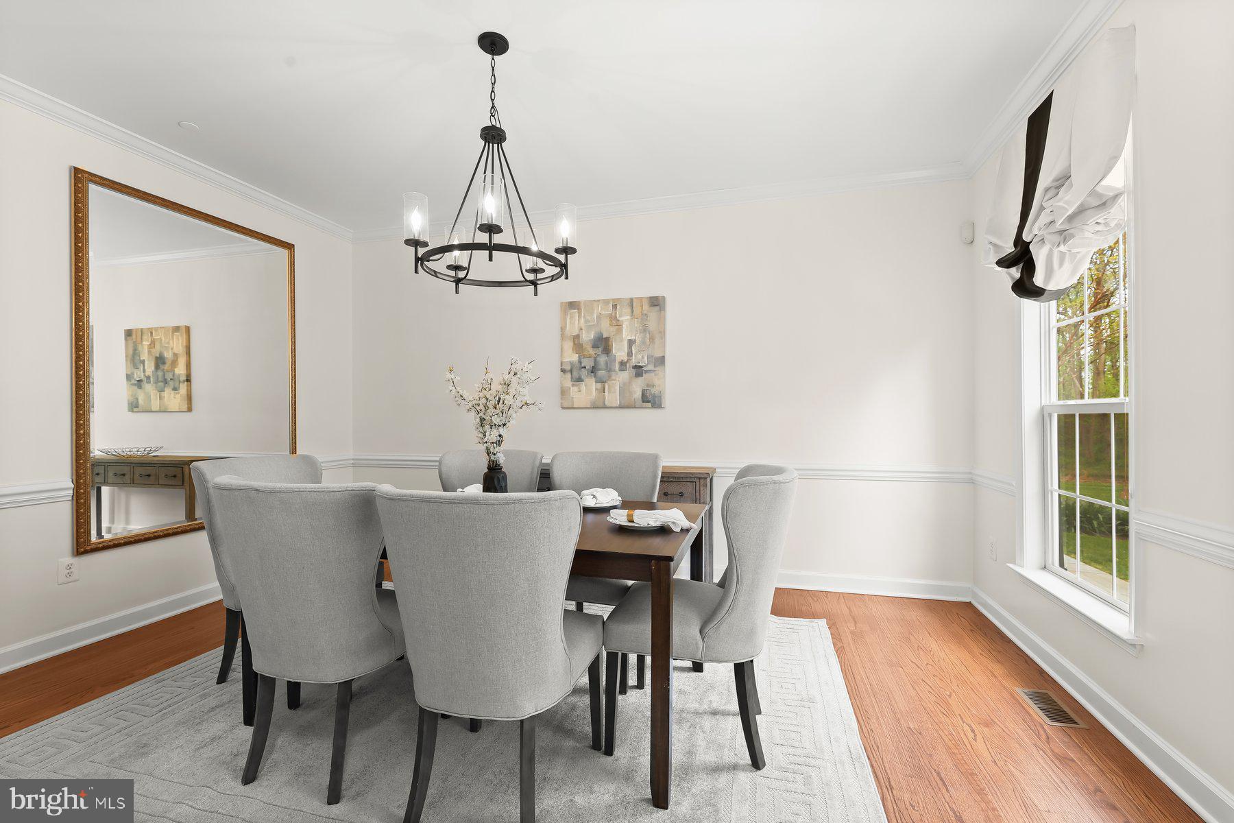 15101 Union Chapel Road Woodbine, MD 21797 - Photo 6 of 93 a dining room with furniture a chandelier and wooden floor