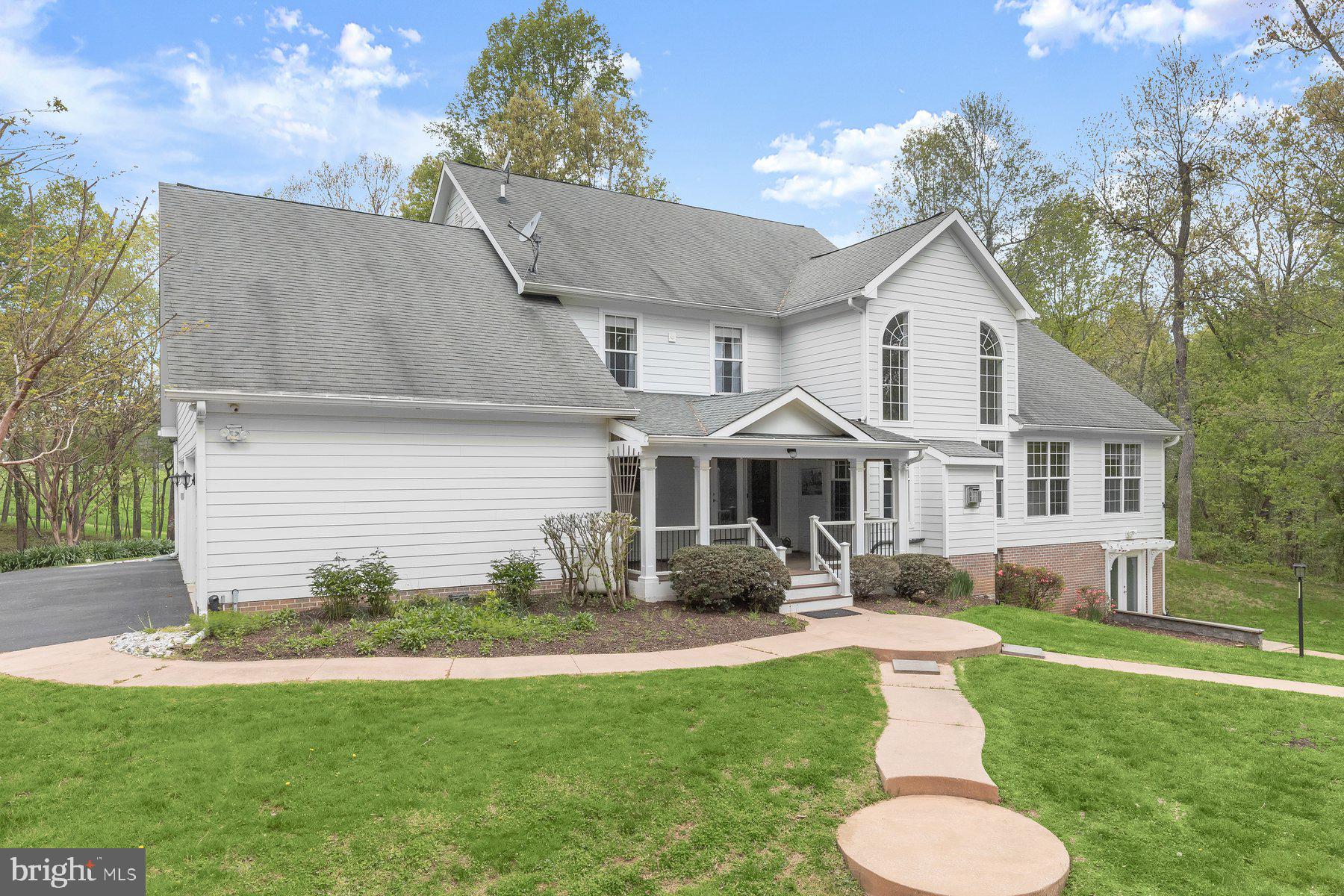 15101 Union Chapel Road Woodbine, MD 21797 - Photo 68 of 93 a front view of a house with a yard and trees