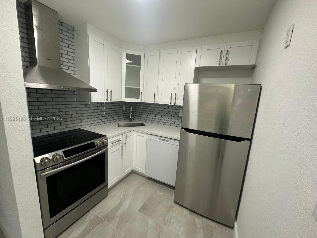 748 82nd Street, Unit 1 Miami Beach, FL 33141 - Photo 3 of 10 a kitchen with a refrigerator sink and stove
