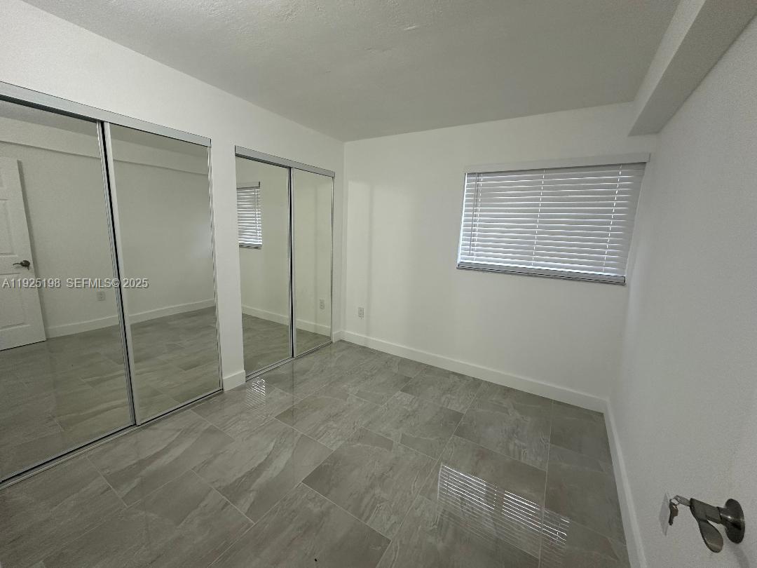 748 82nd Street, Unit 1 Miami Beach, FL 33141 - Photo 4 of 10 a view of an empty room with window
