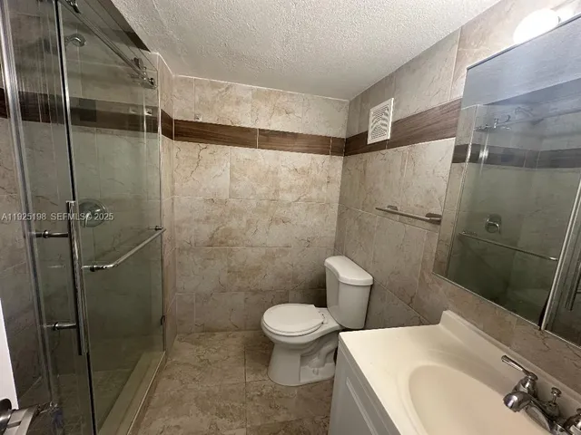 a bathroom with a toilet and shower
