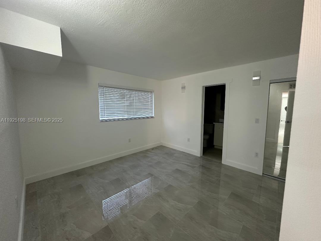 748 82nd Street, Unit 1 Miami Beach, FL 33141 - Photo 7 of 10 an empty room with a bathroom