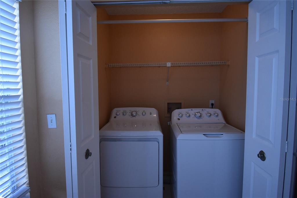 5160 Conroy Road, Unit 1435 Orlando, FL 32811 - Photo 13 of 18 a utility room with dryer and washer