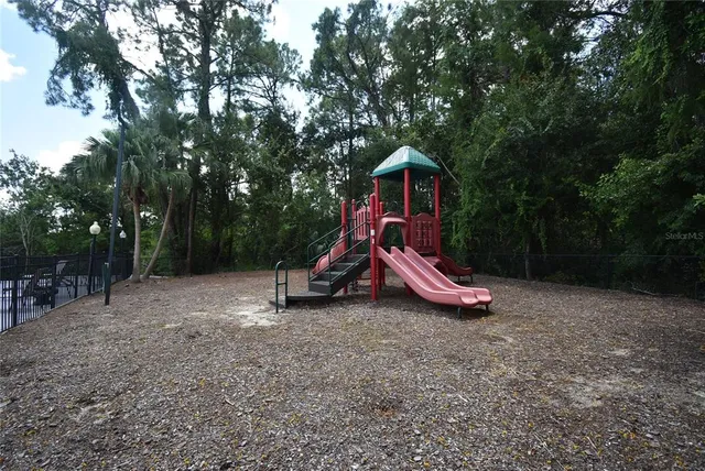 a view of outdoor space with playground and green space