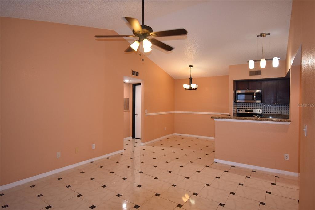 5160 Conroy Road, Unit 1435 Orlando, FL 32811 - Photo 7 of 18 a bedroom with a bed and a chandelier