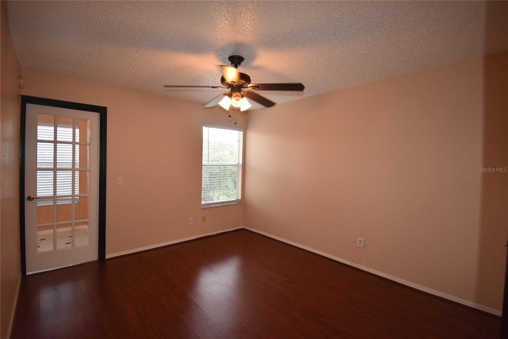 5160 Conroy Road, Unit 1435 Orlando, FL 32811 - Photo 8 of 18 a view of an empty room with wooden floor and a window