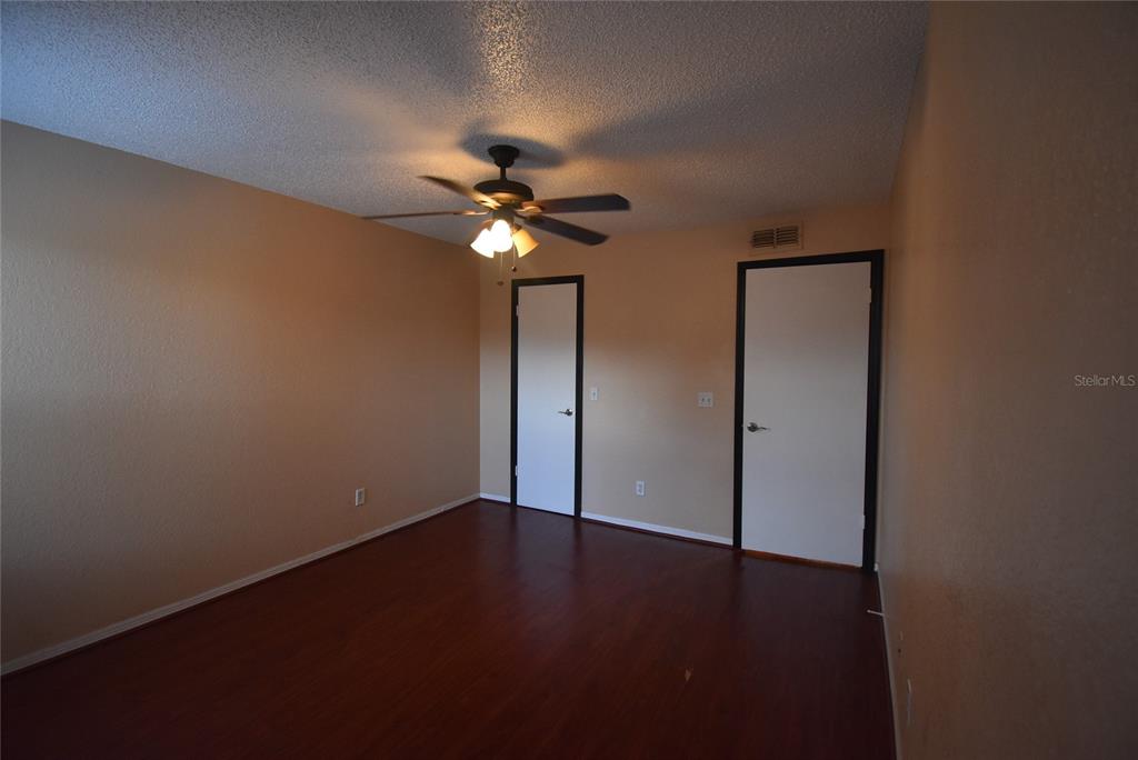 5160 Conroy Road, Unit 1435 Orlando, FL 32811 - Photo 9 of 18 an empty room with wooden floor and windows