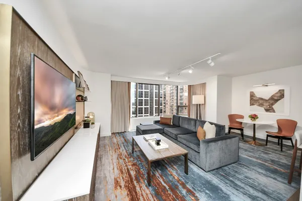 a living room with furniture and a flat screen tv