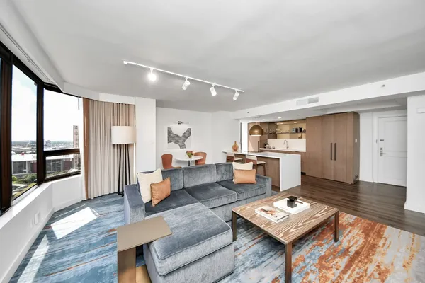 a living room with furniture and a wooden floor